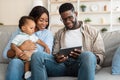 Portrait of african american family using tablet at home Royalty Free Stock Photo