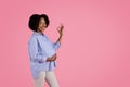 Happy young black pregnant woman in casual touching big belly, show ok sign with hand, enjoy motherhood Royalty Free Stock Photo