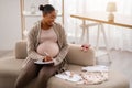 Happy young black pregnant woman getting ready for motherhood Royalty Free Stock Photo