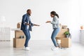 Happy Young Black Spouses Dancing In Their New Flat On Moving Day