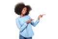 Happy young black woman with afro pointing fingers at copy space Royalty Free Stock Photo