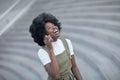 Happy young black woman calling by mobile phone outdoors in the city Royalty Free Stock Photo