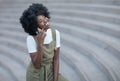 Happy young black woman calling by mobile phone outdoors in the city Royalty Free Stock Photo