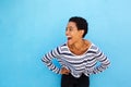 Happy young black woman laughing against blue background Royalty Free Stock Photo