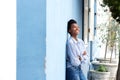 Happy young black woman leaning against wall Royalty Free Stock Photo