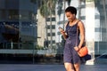 Happy young black woman looking at mobile phone and listening to music Royalty Free Stock Photo