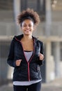 Happy young black woman running outdoors Royalty Free Stock Photo