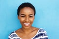 Happy young black woman smiling against blue background Royalty Free Stock Photo