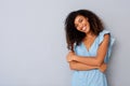 Happy young black woman smiling against gray background Royalty Free Stock Photo