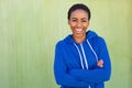 Happy young black woman smiling against green background Royalty Free Stock Photo