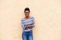 Happy young black woman smiling with arms crossed Royalty Free Stock Photo