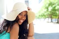 Happy young black woman smiling with sun hat outdoors Royalty Free Stock Photo