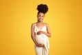 Happy young black woman touching big belly, feels baby move Royalty Free Stock Photo