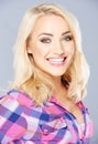 Happy young blond woman with a beaming smile Royalty Free Stock Photo