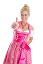 Happy young blond woman in dirndl dress in bavarian folkart. Royalty Free Stock Photo