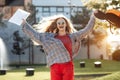 Happy young blonde woman student celebrate success after exams in university. Royalty Free Stock Photo