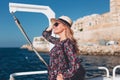 Happy young blonde woman traveling by ferry ship on Mediterranean sea Royalty Free Stock Photo