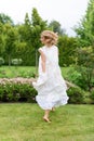 Happy young blonde woman walking barefoot on the green grass Royalty Free Stock Photo