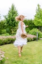 Happy young blonde woman walking barefoot on the green grass Royalty Free Stock Photo