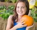 Young Blue Eyed Girl Holding a Fresh Pumpkin at the Farmers Market Royalty Free Stock Photo