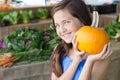 Cute Young Blue Eyed Girl Holding a Fresh Pumpkin at the Farmers Market Royalty Free Stock Photo