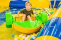 Happy young boy on the boat enjoying playing on amusement park Royalty Free Stock Photo