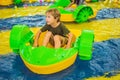 Happy young boy on the boat enjoying playing on amusement park Royalty Free Stock Photo