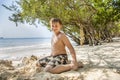 Happy young boy is digging in the sand of the beach Royalty Free Stock Photo