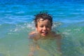 Happy young boy diver swims in the sea Royalty Free Stock Photo