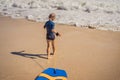 Happy Young boy having fun at the beach on vacation, with Boogie board Royalty Free Stock Photo