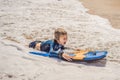 Happy Young boy having fun at the beach on vacation, with Boogie board Royalty Free Stock Photo