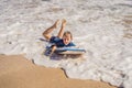 Happy Young boy having fun at the beach on vacation, with Boogie board Royalty Free Stock Photo