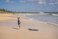 Happy Young boy having fun at the beach on vacation, with Boogie board Royalty Free Stock Photo