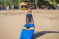 Happy Young boy having fun at the beach on vacation, with Boogie board Royalty Free Stock Photo