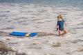 Happy Young boy having fun at the beach on vacation, with Boogie board Royalty Free Stock Photo