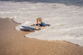 Happy Young boy having fun at the beach on vacation, with Boogie board Royalty Free Stock Photo