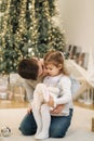 Happy young boy with his niece play in front of fir tree. Christmas mood Royalty Free Stock Photo