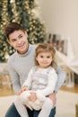 Happy young boy with his niece play in front of fir tree. Christmas mood Royalty Free Stock Photo