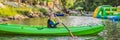 Happy young boy holding paddle in a kayak on the river, enjoying a lovely summer day BANNER, LONG FORMAT Royalty Free Stock Photo