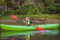 Happy young boy holding paddle in a kayak on the river, enjoying a lovely summer day Royalty Free Stock Photo