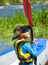 Happy young boy holding paddle near a kayak Royalty Free Stock Photo