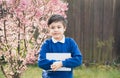 Happy young boy holding tablet pc standing outside waiting for School bus, Portrait  Kid with smiling face standing alone in the Royalty Free Stock Photo