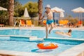 Happy young boy jumping into the pool, swim and dive underwater, kid breast stroke with fun in pool. Active healthy Royalty Free Stock Photo