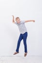 Happy young boy jumping on white background Royalty Free Stock Photo
