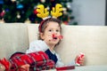 Happy boy playing with a Christmas tree in the background Royalty Free Stock Photo