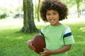 Happy Young Boy Playing In Park With American Football Royalty Free Stock Photo