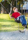 Happy young boy playing on swing Royalty Free Stock Photo