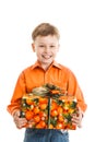 Happy young boy with a present box smiles isolated Royalty Free Stock Photo