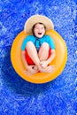 Happy young boy relaxing in a summer pool