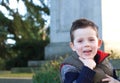 Happy young boy smiling in an outdoor scene Royalty Free Stock Photo